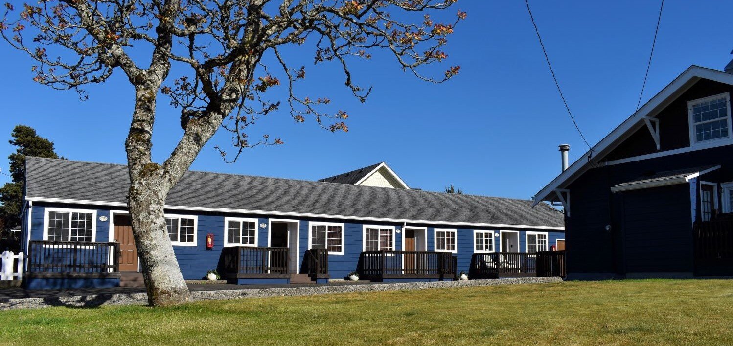 A look at the grassy front lawn and exterior of Estrella Suites in Seaside, Oregon